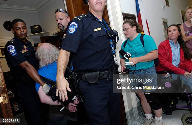 Police carry away protesters from Rep. Joe Barton's office in Rayburn. Members of the American Disabled for Attendant Programs Today held protests...