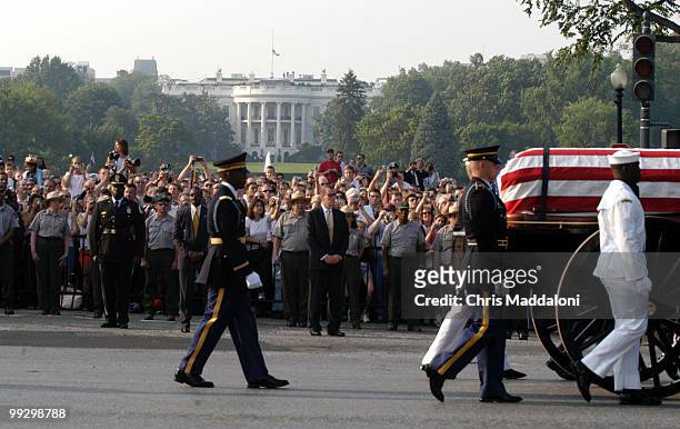 Crowds watch the 3rd Infantry Division Old Guard transfer former President Ronald Reagan's casket to a horse-drawn caisson to take him to to lie in...
