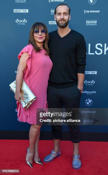 July 2018, Berlin, Germany: Simone Thomalla, actress, and Silvio Heinevetter, handball player arrive for the presentation of the label Michalsky at...