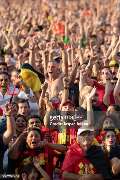 Belgian football fans celebrate their teams opening goal during the World Cup Quarter Final match between Brazil and Belgium at a fan village on July...