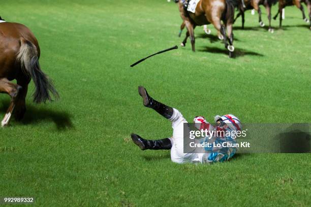 Jockey Ben So Tik-hung dislodged after finish line from horse Telecom Man during the Race 4 Carnation Handicap at Happy Valley Racecourse on July 4,...