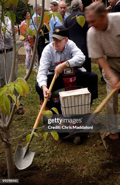 Max Blanchard Class of 1955, from Albuquerque, New Mexico, helps shovel dirt on a Flowering Dogwood on the south corner of the West Front lawn. The...