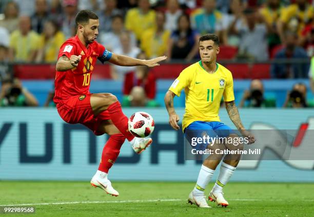 Eden Hazard of Belgium controls the ball under pressure from Philippe Coutinho of Brazil during the 2018 FIFA World Cup Russia Quarter Final match...