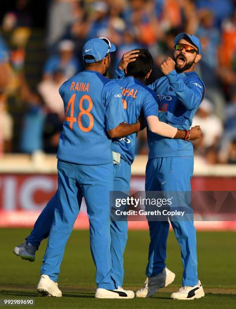 India captain Virat Kohli celebrates with Yuzvendra Chahal after he dismisses Joe Root of England during the 2nd Vitality International T20 match...