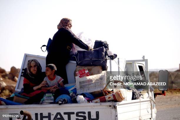 Syrian family returns to their homes in towns and villages situated on the eastern outskirts of Daraa on July 6, 2018. - The Syrian regime reached a...