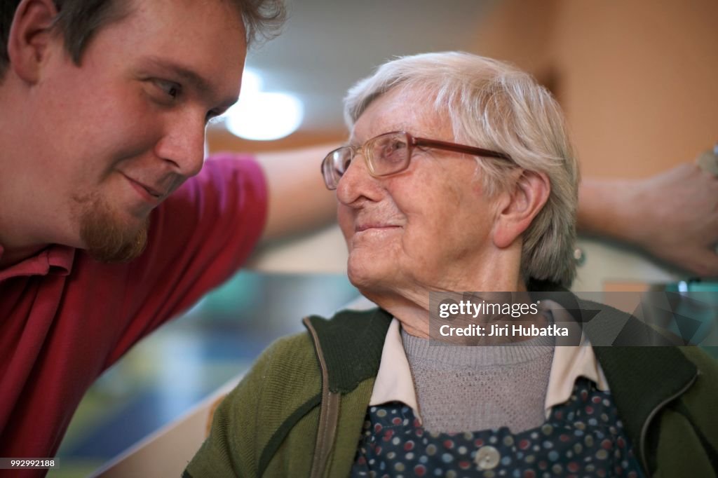 Woman, 89 years, talking to a nurse for the elderly, nursing home