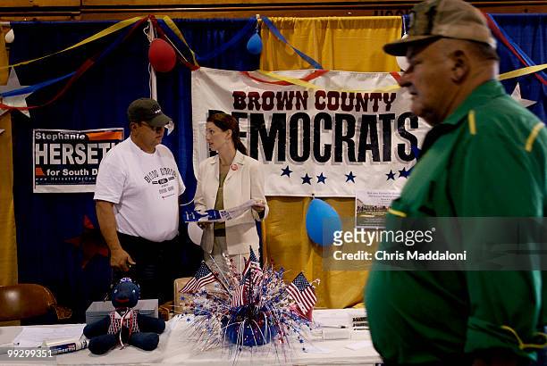 Volunteer gary Job, a former Democrat county chair, speaks with Rep. Stephanie Herseth, D-SD, at the Democratic Party booth at the Brown County Fair....