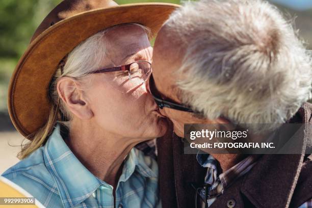 old cowboy kiss - tough love stock pictures, royalty-free photos & images