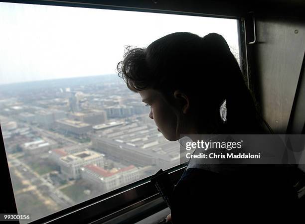 Ashley Barker from Twinsburg, Ohio, looks out at the top of the Washington Monument, closed since Labor Day, which reopened today.