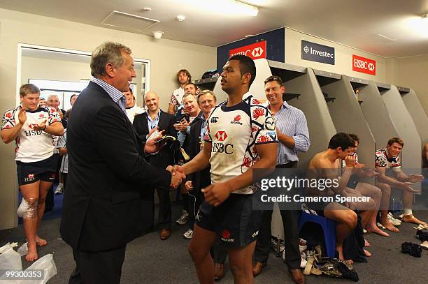 Kurtley Beale of the Waratahs receives his 50th cap for the Waratahs from coach Chris Hickey after winning the 14 Super 14 match between the Waratahs...