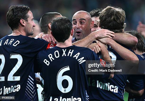 Kevin Muscat of the Victory is congratulated by teammates after setting up a penalty for Semir Sivic to score during the Kevin Muscat Testimonial...