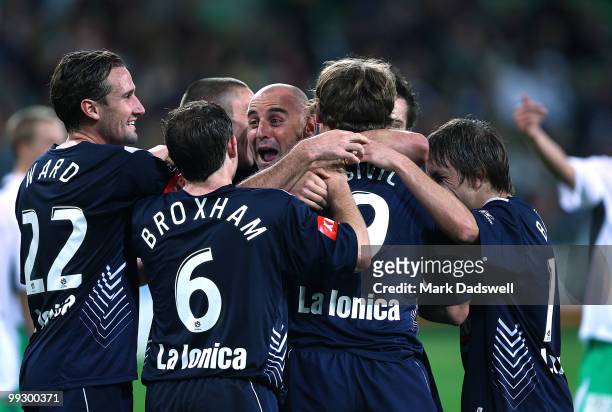 Kevin Muscat of the Victory is congratulated by teammates after setting up a penalty for Semir Sivic to score during the Kevin Muscat Testimonial...