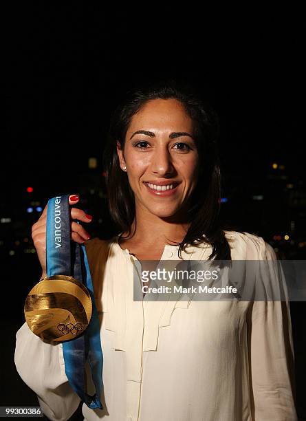 Lydia Lassila poses with an Olympic Gold medal whilst attending the AOC cocktail party to welcome home the 2010 Winter Olympic Team at Sydney...