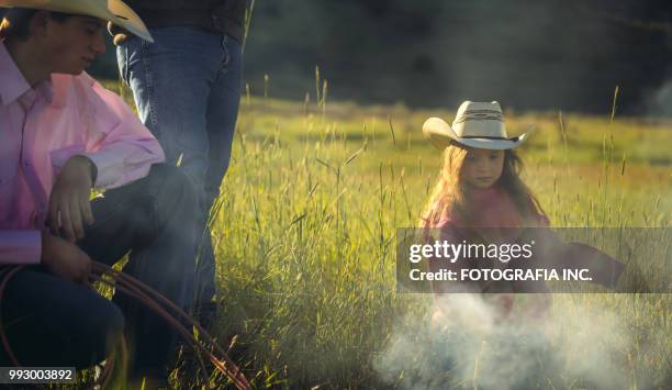 utah rancher family by the bonfire - retro cowgirl stock pictures, royalty-free photos & images