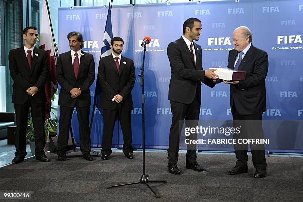 Chairman of Quatar 2022 bid committee Sheik Mohammed bin Hamad Al Thani delivers the bid book to FIFA president Sepp Blatter during an official...