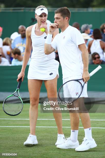 Neal Skupski and Naomi Broady of Great Britain talk against Joe Salisbury and Katy Dunne of Great Britain during their Mixed Doubles first round...