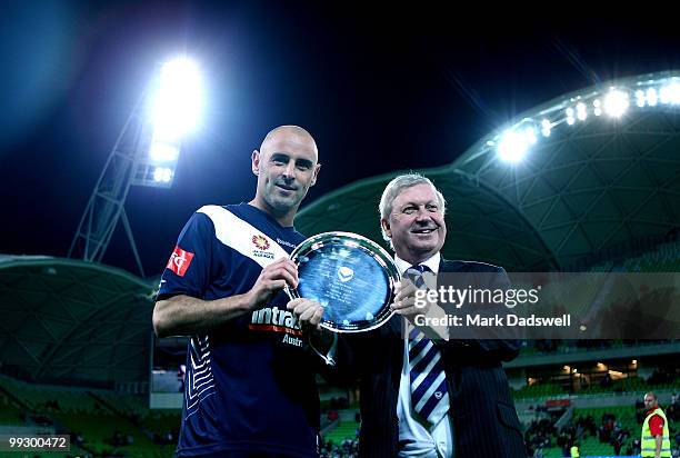 Kevin Muscat of the Victory is presented with a trophy by the Chairman of the club Geoff Lord at the completion of the Kevin Muscat Testimonial match...