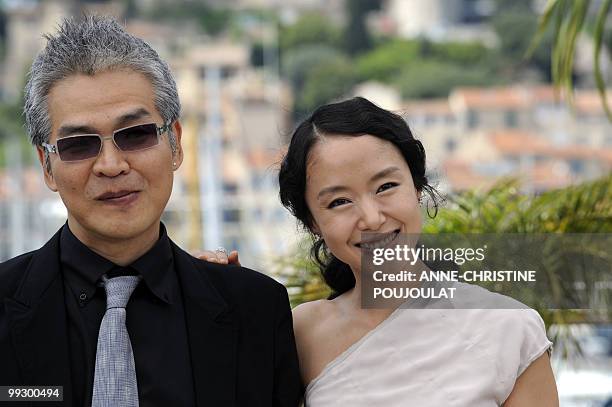 South Korean director Im Sang soo poses with South Korean actress Jeon Do-yeoun during the photocall of "The Housemaid" presented in competition at...