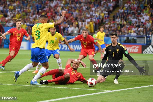 Vincent Kompany of Belgium tackles Gabriel Jesus of Brazil inside the penalty area during the 2018 FIFA World Cup Russia Quarter Final match between...