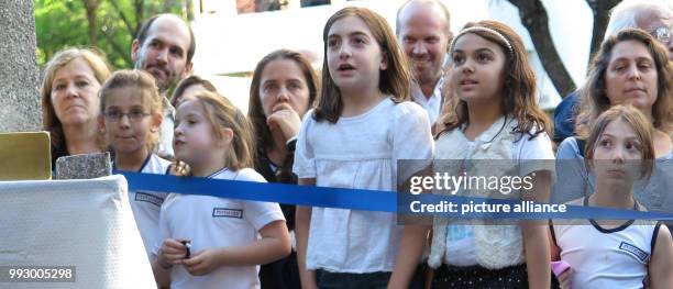 Pupils and children watch the laying of a Stolperstein at the Pestalozzi-Schule in Buenos Aires, Argentina, 30 October 2017. The memorial honours the...