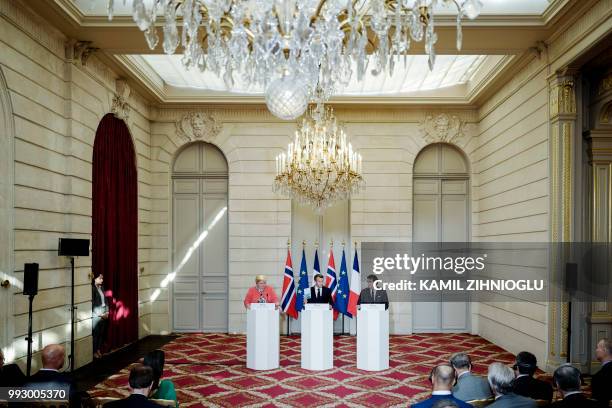 French President Emmanuel Macron, Norway's Prime Minister Erna Solberg and Saudi Arabia's Yasir Al-Rumayyan, the Managing Director of the Public...