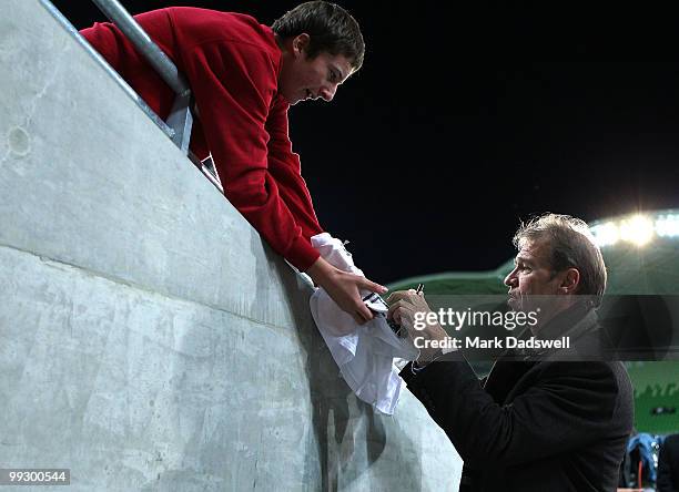 Pim Verbeek coach of the Socceroos signs autographs for fans during the Kevin Muscat Testimonial match between Melbourne Victory and the Come Play XI...