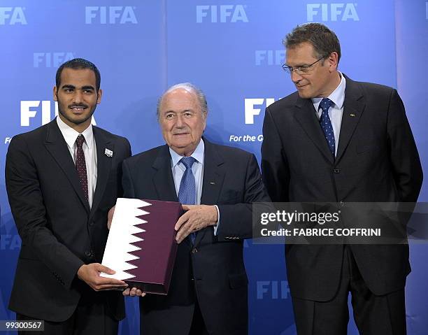 Chairman of Quatar 2022 bid committee Sheik Mohammed bin Hamad Al Thani, FIFA president Sepp Blatter and FIFA Secretary General Jerome Valcke pose...