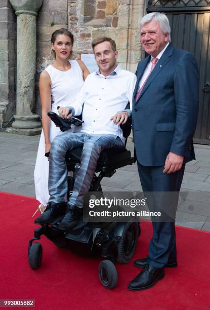 July 2018, Bad Hersfeld, Germany: Volker Bouffier , premiere of Hesse poses with Samuel Koch, actor and his wife Sarah Koch, also an actress, at the...