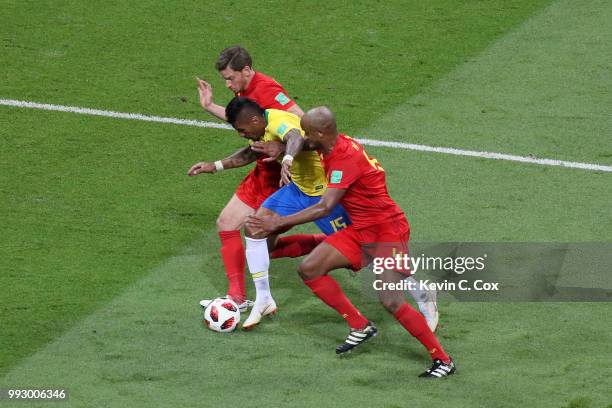 Paulinho of Brazil is challenged by Vincent Kompany and Jan Vertonghen of Belgium during the 2018 FIFA World Cup Russia Quarter Final match between...