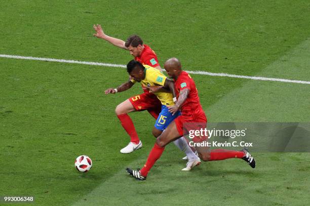 Paulinho of Brazil is challenged by Vincent Kompany and Jan Vertonghen of Belgium during the 2018 FIFA World Cup Russia Quarter Final match between...