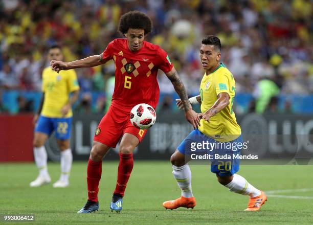 Axel Witsel of Belgium is challenged by Roberto Firmino of Brazil during the 2018 FIFA World Cup Russia Quarter Final match between Brazil and...