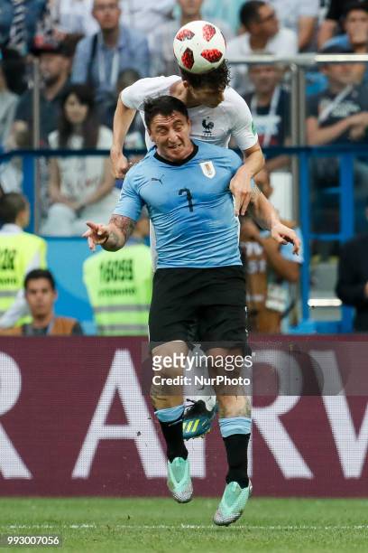 Cristian Rodriguez of Uruguay national team and Benjamin Pavard of France national team vie for a header during the 2018 FIFA World Cup Russia...