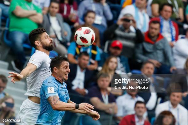Cristian Rodriguez of Uruguay national team and Olivier Giroud of France national team vie for a header during the 2018 FIFA World Cup Russia Quarter...