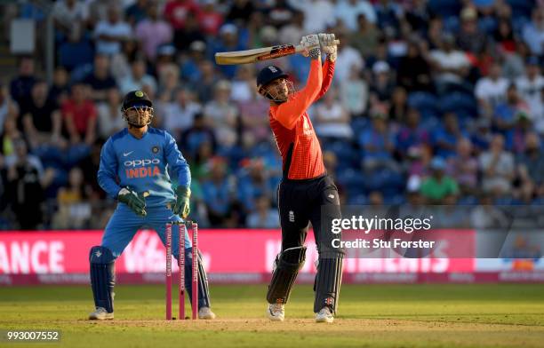 India keeper MS Dhoni looks on as Alex Hales hits a six during the 2nd Vitality T20 International between England and India at Sophia Gardens on July...