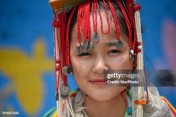 Portrait of Tibetan girl in a traditional attire during the 83rd birthday celebration of the exiled spiritual leader the Dalai Lama in Lalitpur,...