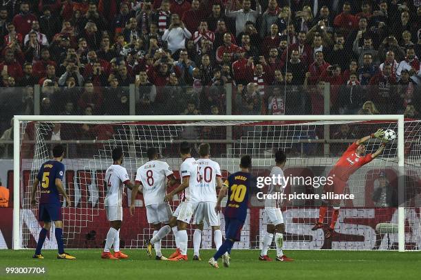 Dpatop - Olympiacos goalkeeper Silvio Proto saves a free kick by Barcelona's Lionel Messi during the UEFA Champions League Group D football match at...