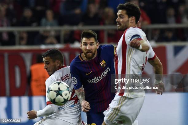 Barcelona's Lionel Messi fights for the ball with Olympiacos' FC Alberto Botia during Group D, UEFA Champions League football match between...