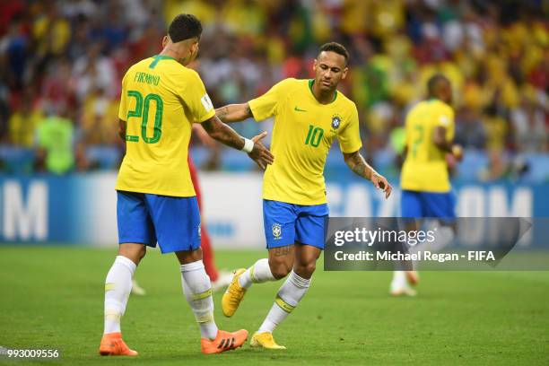 Neymar Jr and Roberto Firmino of Brazil celebrate their team's first goal during the 2018 FIFA World Cup Russia Quarter Final match between Brazil...