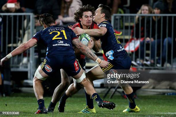 George Bridge of the Crusaders is tackled by Ben Smith of the Highlanders during the round 18 Super Rugby match between the Crusaders and the...
