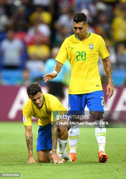 Roberto Firmino of Brazil checks if team mate Philippe Coutinho is ok during the 2018 FIFA World Cup Russia Quarter Final match between Brazil and...