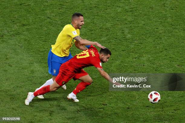 Eden Hazard of Belgium is challenged by Renato Augusto of Brazil during the 2018 FIFA World Cup Russia Quarter Final match between Brazil and Belgium...