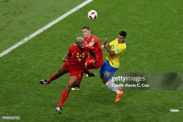 Vincent Kompany of Belgium wins a header over team mate Thomas Vermaelen and Roberto Firmino of Brazil during the 2018 FIFA World Cup Russia Quarter...