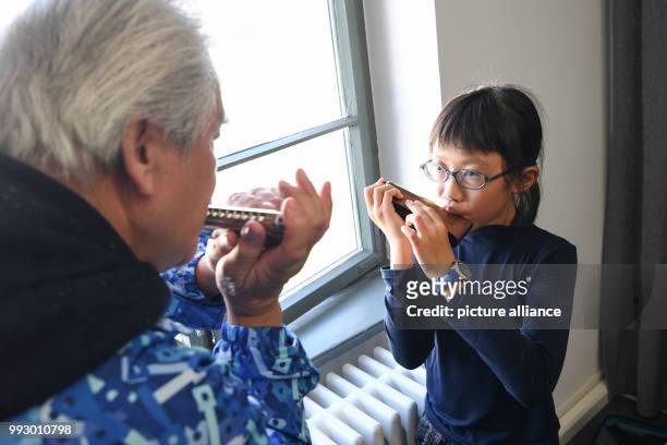 Lenng Tsz Kiu Amanda of the Kings College Old Boys Association from Hong Kong warms up with his harmonica in Trossingen, Germany, 1 November 2017....
