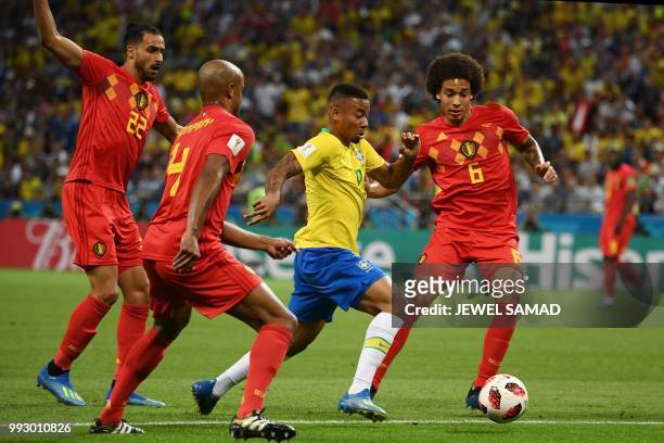 Brazil's forward Gabriel Jesus is marked by Belgium's midfielder Axel Witsel and Belgium's defender Vincent Kompany during the Russia 2018 World Cup...