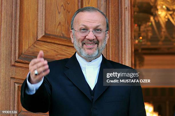 Iranian Foreign Minister Manoucher Mottaki poses next to his Turkish counterpart Ahmet Davutoglu before their offical meeting in Istanbul, on May 7,...