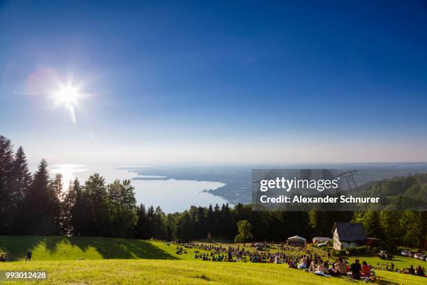 evening atmosphere on mt pfaender, sommer soltice festival with views of lake constance, bregenz, vorarlberg, austria - bregenz stock pictures, royalty-free photos & images