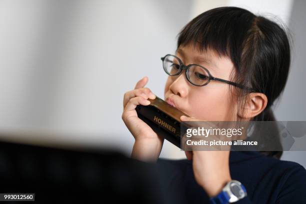 Lenng Tsz Kiu Amanda of the Kings College Old Boys Association from Hong Kong warms up with his harmonica in Trossingen, Germany, 1 November 2017. It...