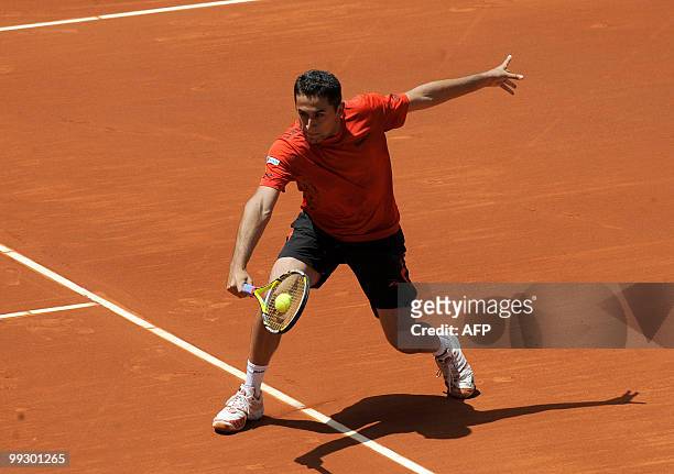 Spaniard Nicolas Almagro returns a ball to Austrian Jurgen Melzer during their Madrid Masters match on May 14, 2010 at the Caja Magic sports complex...