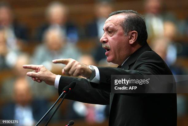 Turkish Prime Minister Tayyip Erdogan addresses parliament members of his ruling Justice and Developement Party at the Turkish Parliament in Ankara...