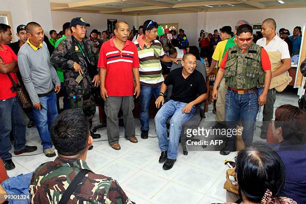 Esmael Mangudadatu is flanked by seucity as he waits for his proclamation as the new governor by Commission on elections officials at the provincial...